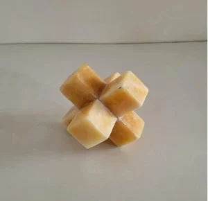 Handcrafted marble cube sculpture with interlocking geometric design on a neutral background Minimalist marble decor piece featuring a unique cube structure for modern interiors Luxury stone cube sculpture placed on a clean surface for home decor styling Artistic marble geometric cube object with smooth finish and natural texture Modern marble cube decor accent with symmetrical design for living room or desk Close-up of handcrafted marble sculpture with interlocking cube pattern